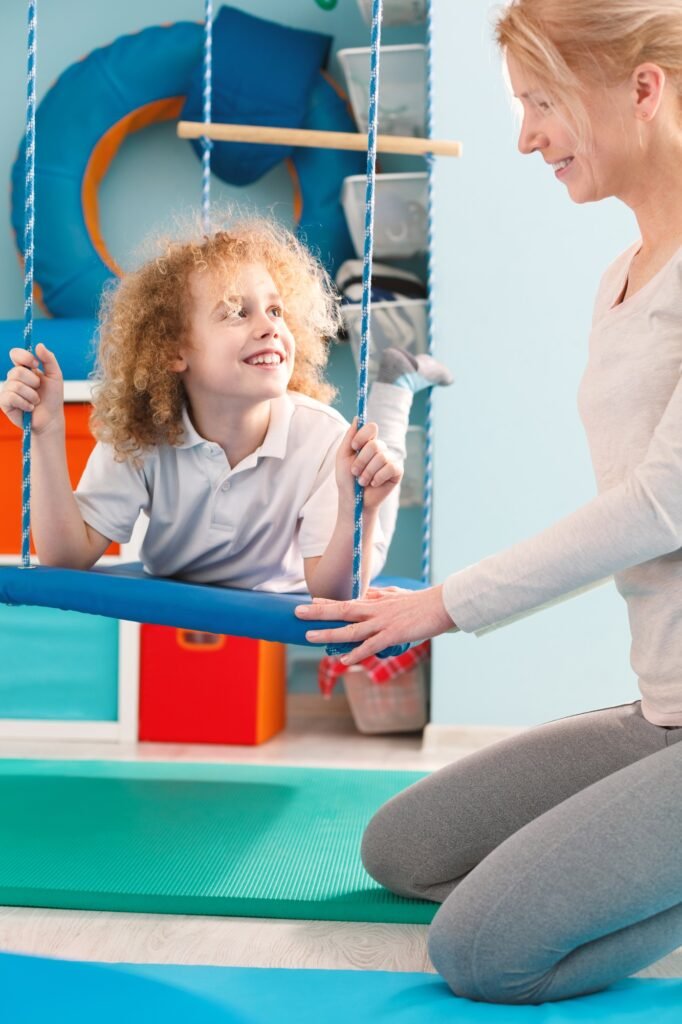 Boy using therapy swing